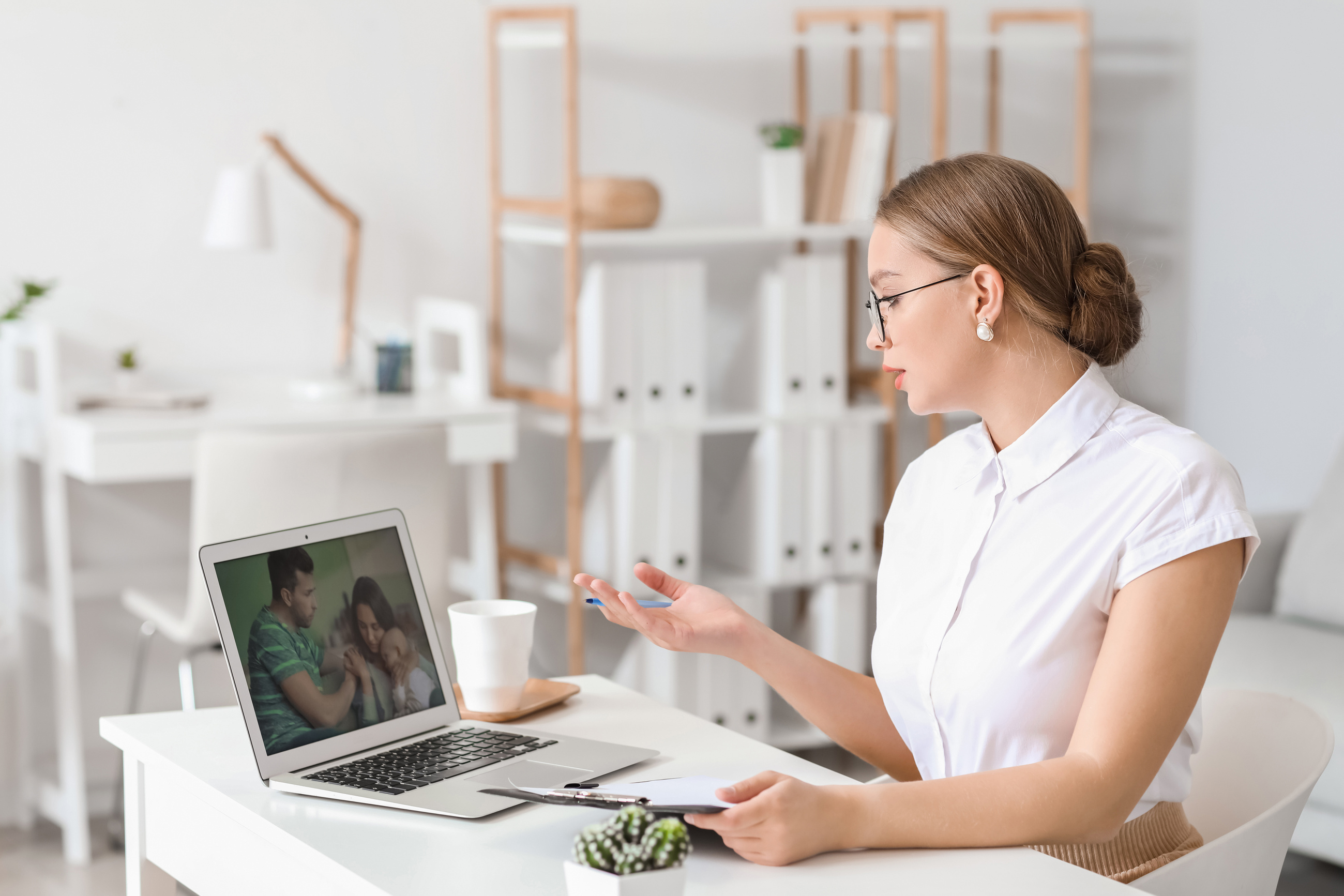 Psychologist Working with Family Online While Sitting in Office